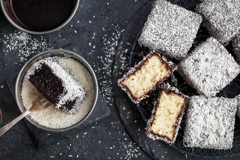 Square-Shaped Sponge Cakes dipped in Chocolate and Sprinkled with Coconut